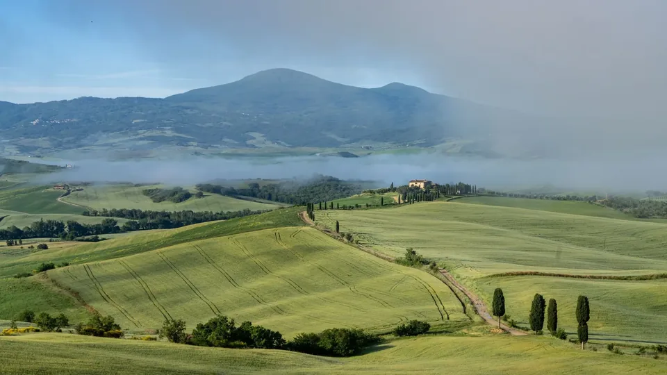 Green hills near San Quirico d’Orcia, Monte Amiata in the mist.